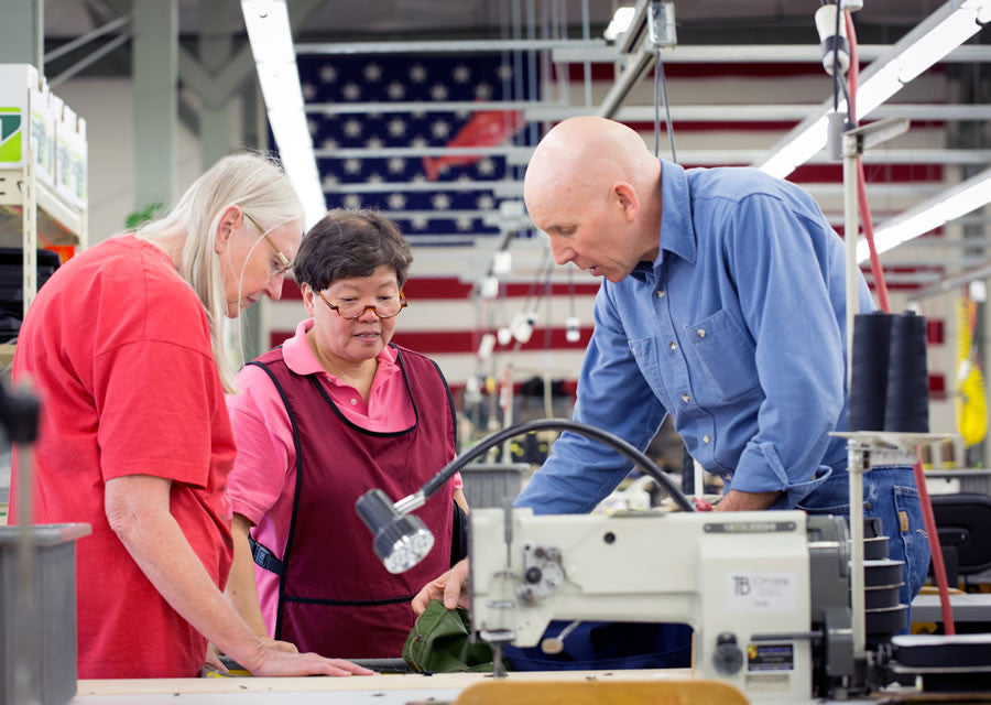 Tom, June, and Fong looking at a pattern piece